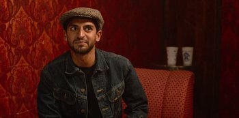 Movie still from “Always Be My Maybe” (2019), directed by Nahnatchka Khan – A man wearing a jean jacket and a hat; Close Up shot, Over the shoulder angle