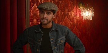 Movie still from “Always Be My Maybe” (2019), directed by Nahnatchka Khan – A man wearing a jean jacket and a hat; Close Up shot, Over the shoulder angle