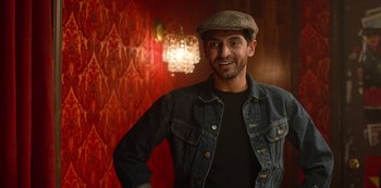 Movie still from “Always Be My Maybe” (2019), directed by Nahnatchka Khan – A man wearing a jean jacket and a hat; Medium shot, Over the shoulder angle