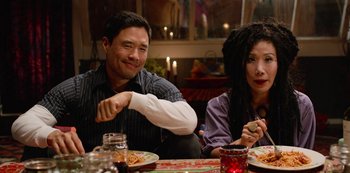 Movie still from “Always Be My Maybe” (2019), directed by Nahnatchka Khan – A man and a woman sitting at a dinner table; Medium shot, Over the shoulder angle