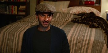 Movie still from “Always Be My Maybe” (2019), directed by Nahnatchka Khan – A man wearing a hat sitting in front of a bed; Close Up shot, Over the shoulder angle
