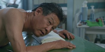 Movie still from “Always Be My Maybe” (2019), directed by Nahnatchka Khan – A person laying on a table; Close Up shot, Low angle