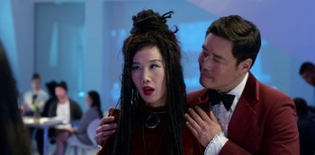 Movie still from “Always Be My Maybe” (2019), directed by Nahnatchka Khan – A woman with dreads is being styled by a man in a suit; Close Up shot, Over the shoulder angle
