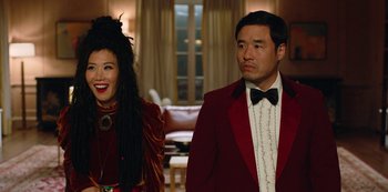 Movie still from “Always Be My Maybe” (2019), directed by Nahnatchka Khan – A man and a woman standing next to each other in a room; Medium shot, Over the shoulder angle