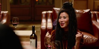 Movie still from “Always Be My Maybe” (2019), directed by Nahnatchka Khan – A woman sitting at a table with a glass of red wine; Close Up shot, Over the shoulder angle