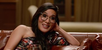 Movie still from “Always Be My Maybe” (2019), directed by Nahnatchka Khan – A woman wearing glasses sitting on top of a couch; Close Up shot, Over the shoulder angle