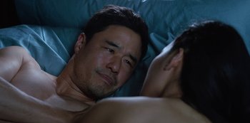Movie still from “Always Be My Maybe” (2019), directed by Nahnatchka Khan – A person laying in bed with a man; Close Up shot, Over the shoulder angle