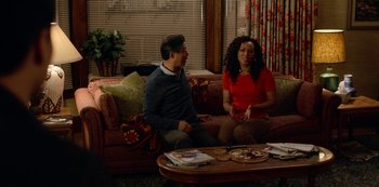 Movie still from “Always Be My Maybe” (2019), directed by Nahnatchka Khan – A man and a woman sitting on a red couch; Medium shot, Over the shoulder angle