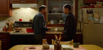 Movie still from “Always Be My Maybe” (2019), directed by Nahnatchka Khan – Two men standing in a kitchen talking to each other; Medium shot, Over the shoulder angle