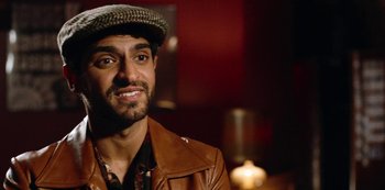 Movie still from “Always Be My Maybe” (2019), directed by Nahnatchka Khan – A person wearing a hat and a leather jacket; Close Up shot, Over the shoulder angle