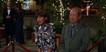 Movie still from “Always Be My Maybe” (2019), directed by Nahnatchka Khan – A man and a woman standing next to each other in front of lights; Medium shot, Over the shoulder angle