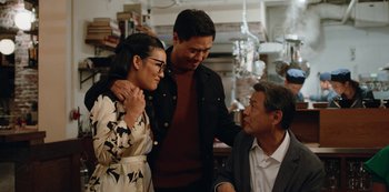 Movie still from “Always Be My Maybe” (2019), directed by Nahnatchka Khan – A group of people standing next to each other in a room; Medium shot, Over the shoulder angle