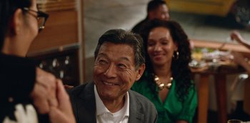 Movie still from “Always Be My Maybe” (2019), directed by Nahnatchka Khan – An older man and a young woman smile for a picture; Close Up shot, Over the shoulder angle