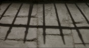 Movie still from “The Long Day Closes” (1992), directed by Terence Davies – The shadow of a jail cell is cast on the floor; Extreme Close Up shot, Overhead angle