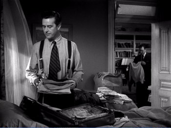 Movie still from “The Lost Weekend” (1945), directed by Billy Wilder – A black and white photo of a man packing his suitcase; Medium shot, Over the shoulder angle