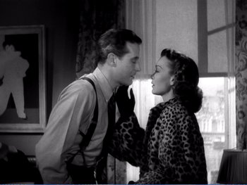 Movie still from “The Lost Weekend” (1945), directed by Billy Wilder – A man and a woman kissing in front of a window; Medium shot, Over the shoulder angle