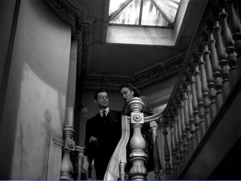 Movie still from “The Lost Weekend” (1945), directed by Billy Wilder – A man and a woman standing on a staircase; Medium shot, Low angle