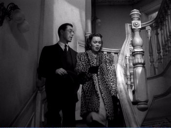 Movie still from “The Lost Weekend” (1945), directed by Billy Wilder – A man and a woman standing next to each other on stairs; Medium shot, High angle