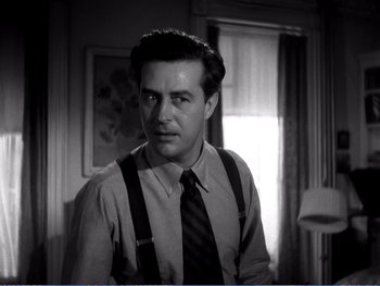 Movie still from “The Lost Weekend” (1945), directed by Billy Wilder – Black and white photograph of a man wearing a tie and suspenders; Close Up shot, Low angle