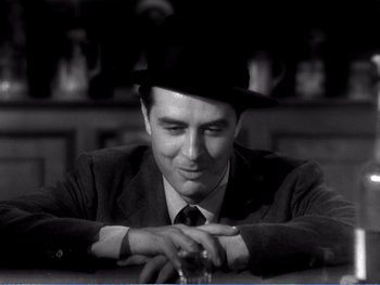 Movie still from “The Lost Weekend” (1945), directed by Billy Wilder – A black and white photo of a man wearing a hat; Close Up shot, Low angle