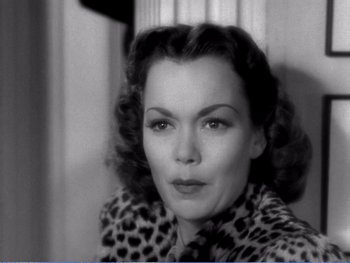 Movie still from “The Lost Weekend” (1945), directed by Billy Wilder – A black - and - white photo of a woman in a leopard print jacket; Close Up shot, High angle