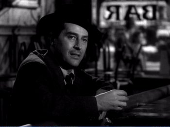 Movie still from “The Lost Weekend” (1945), directed by Billy Wilder – A black and white photo of a man wearing a hat; Close Up shot, Over the shoulder angle