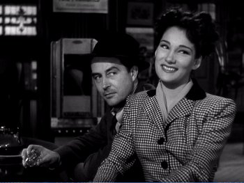 Movie still from “The Lost Weekend” (1945), directed by Billy Wilder – A man and a woman sitting next to each other; Medium shot, Low angle