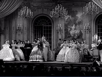 Movie still from “The Lost Weekend” (1945), directed by Billy Wilder – A black and white photo of people dressed in period costumes; Extreme Wide shot, Low angle