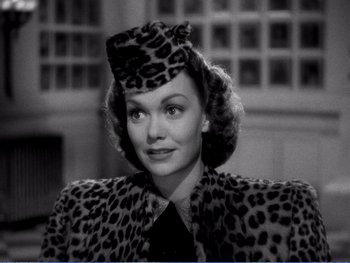 Movie still from “The Lost Weekend” (1945), directed by Billy Wilder – A black and white photo of a woman in a leopard print outfit; Medium shot, High angle