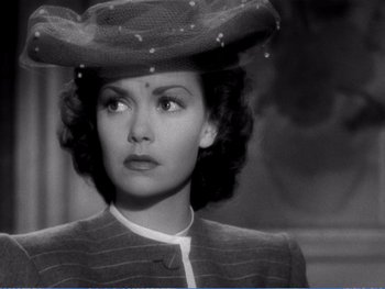 Movie still from “The Lost Weekend” (1945), directed by Billy Wilder – An old photo of a woman wearing a hat; Close Up shot, Low angle