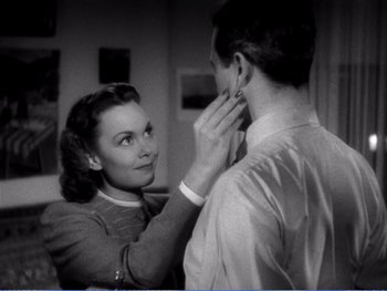 Movie still from “The Lost Weekend” (1945), directed by Billy Wilder – An old photo of a man and a woman looking at each other; Close Up shot, Over the shoulder angle