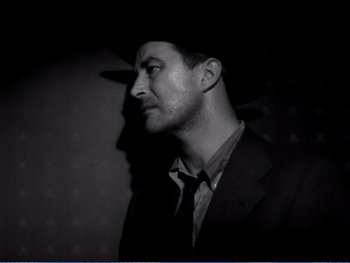 Movie still from “The Lost Weekend” (1945), directed by Billy Wilder – A black and white photo of a man wearing a cowboy hat; Close Up shot, Low angle