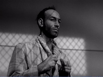 Movie still from “The Lost Weekend” (1945), directed by Billy Wilder – Black and white photograph of a man in a striped robe; Close Up shot, Low angle