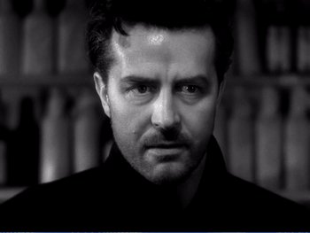 Movie still from “The Lost Weekend” (1945), directed by Billy Wilder – Black and white photograph of a man with a serious look; Close Up shot, Low angle