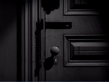 A black door with a door knob on it