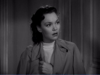 Movie still from “The Lost Weekend” (1945), directed by Billy Wilder – A black - and - white photo of a woman wearing a trench coat; Close Up shot, High angle