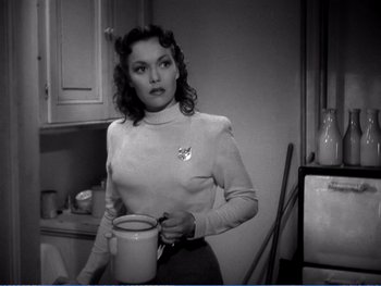 Movie still from “The Lost Weekend” (1945), directed by Billy Wilder – A black and white photo of a woman holding a coffee mug; Medium shot, Over the shoulder angle