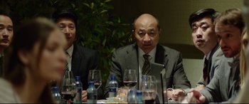 Movie still from “The Man Who Killed Don Quixote” (2018), directed by Terry Gilliam – Two men sitting at a table with wine glasses; Medium shot, Over the shoulder angle