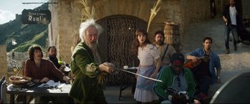 Movie still from “The Man Who Killed Don Quixote” (2018), directed by Terry Gilliam – A group of people standing around with swords; Medium shot, Over the shoulder angle