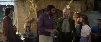 Movie still from “The Man Who Killed Don Quixote” (2018), directed by Terry Gilliam – Two men standing next to each other in front of a brick wall; Medium shot, Over the shoulder angle