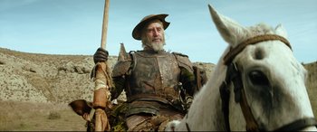 Movie still from “The Man Who Killed Don Quixote” (2018), directed by Terry Gilliam – A man dressed as a medieval knight on horseback; Medium shot, Low angle