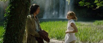 Movie still from “The Man Who Killed Don Quixote” (2018), directed by Terry Gilliam – A man and a woman sitting next to each other near a waterfall; Medium shot, Over the shoulder angle