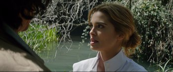 Movie still from “The Man Who Killed Don Quixote” (2018), directed by Terry Gilliam – A woman in a white shirt and tie looking off into the distance; Close Up shot, Over the shoulder angle