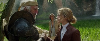 Movie still from “The Man Who Killed Don Quixote” (2018), directed by Terry Gilliam – A man and a woman shake hands while another woman looks on; Medium shot, Over the shoulder angle
