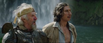 Movie still from “The Man Who Killed Don Quixote” (2018), directed by Terry Gilliam – Two men standing next to each other in front of a waterfall; Medium shot, Low angle