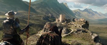 Movie still from “The Man Who Killed Don Quixote” (2018), directed by Terry Gilliam – A person riding a horse on top of a mountain; Extreme Wide shot, High angle