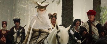 Movie still from “The Man Who Killed Don Quixote” (2018), directed by Terry Gilliam – A couple of people riding on the back of a white horse; Medium shot, Low angle