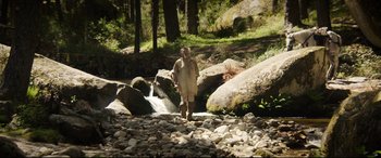 Movie still from “The Man Who Killed Don Quixote” (2018), directed by Terry Gilliam – A man standing in the middle of a stream; Wide shot, High angle
