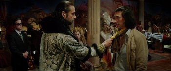 Movie still from “The Man Who Killed Don Quixote” (2018), directed by Terry Gilliam – A man in a costume is handing a banana to another man in a costume; Medium shot, Over the shoulder angle