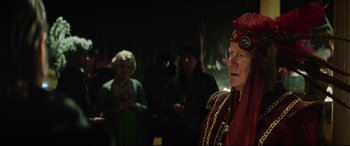 Movie still from “The Man Who Killed Don Quixote” (2018), directed by Terry Gilliam – A group of people standing in a dark room; Medium shot, Over the shoulder angle